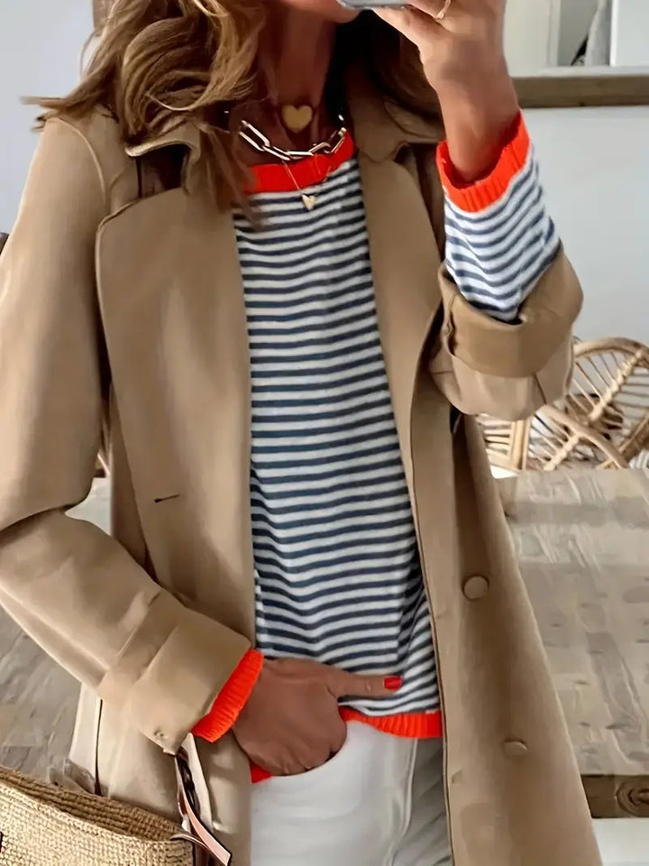 Women's black and white striped jumper with orange ribbed trims