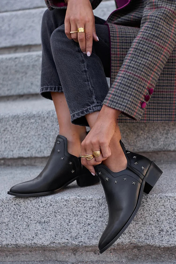 Black pointed toe ankle boots with silver star studs and block heels