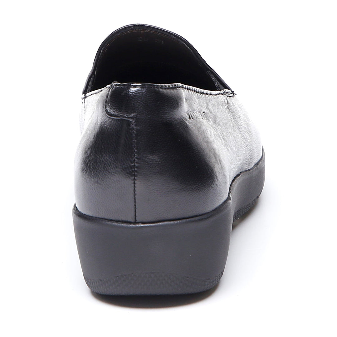 Women's black slip-on loafer with rounded toe and low wedge sole