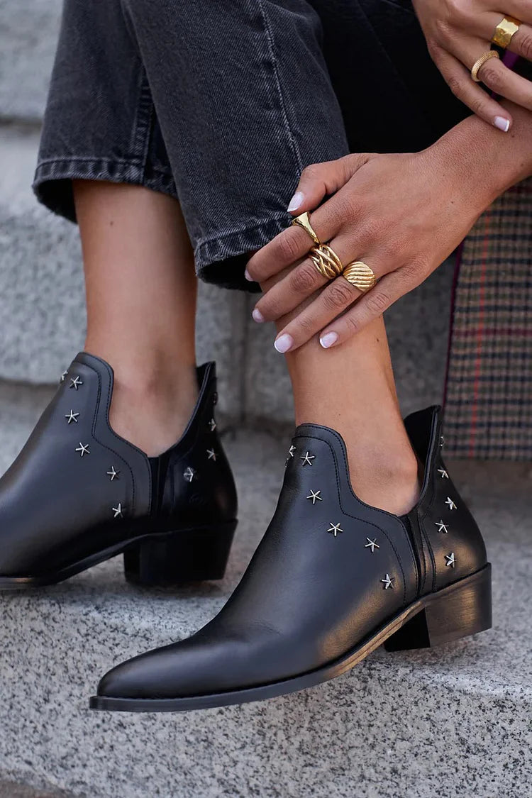 Black pointed toe ankle boots with silver star studs and block heels