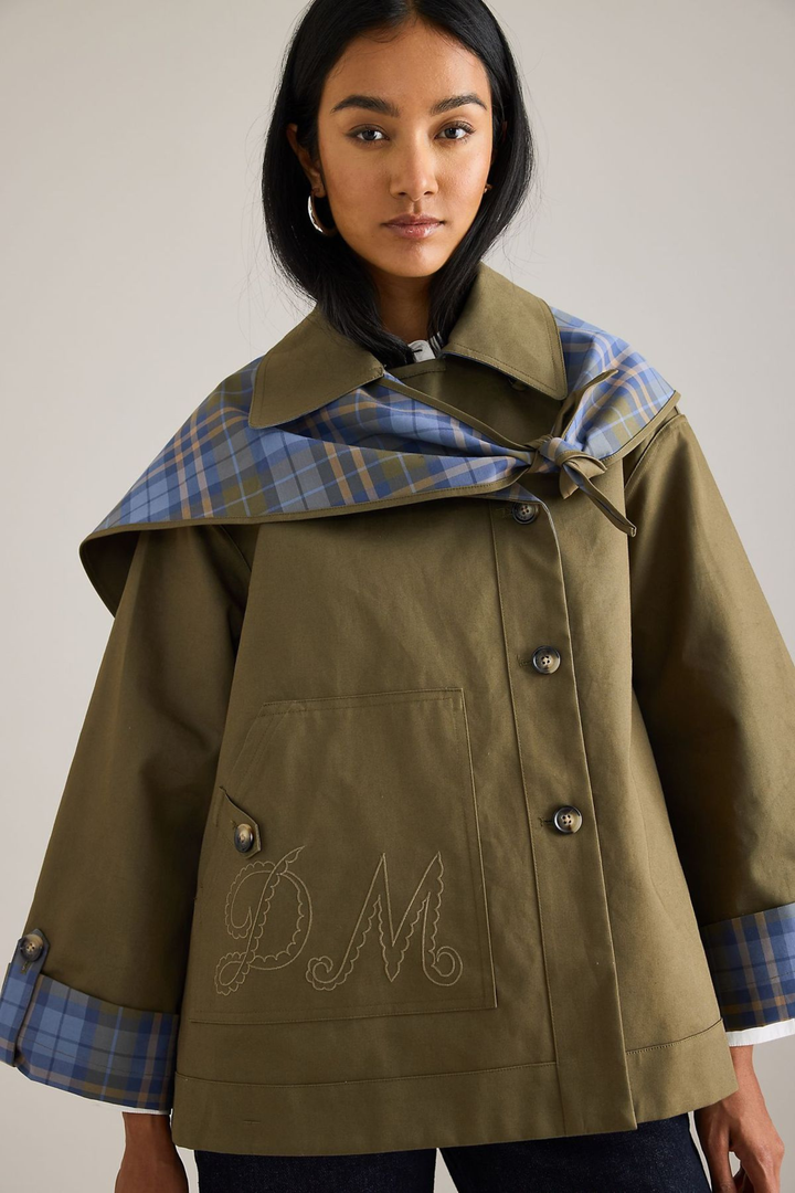 Women's brown jacket with blue plaid trim, raised collar and button front