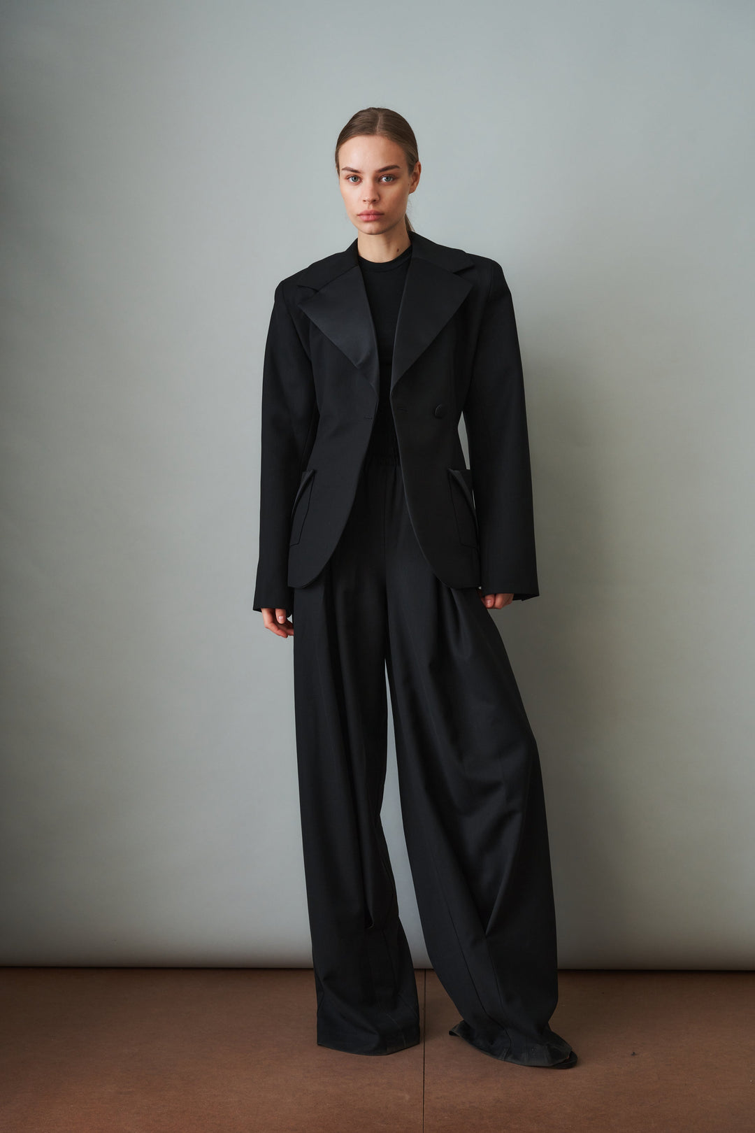 Women's black sculpted blazer with notched lapels and flap pockets