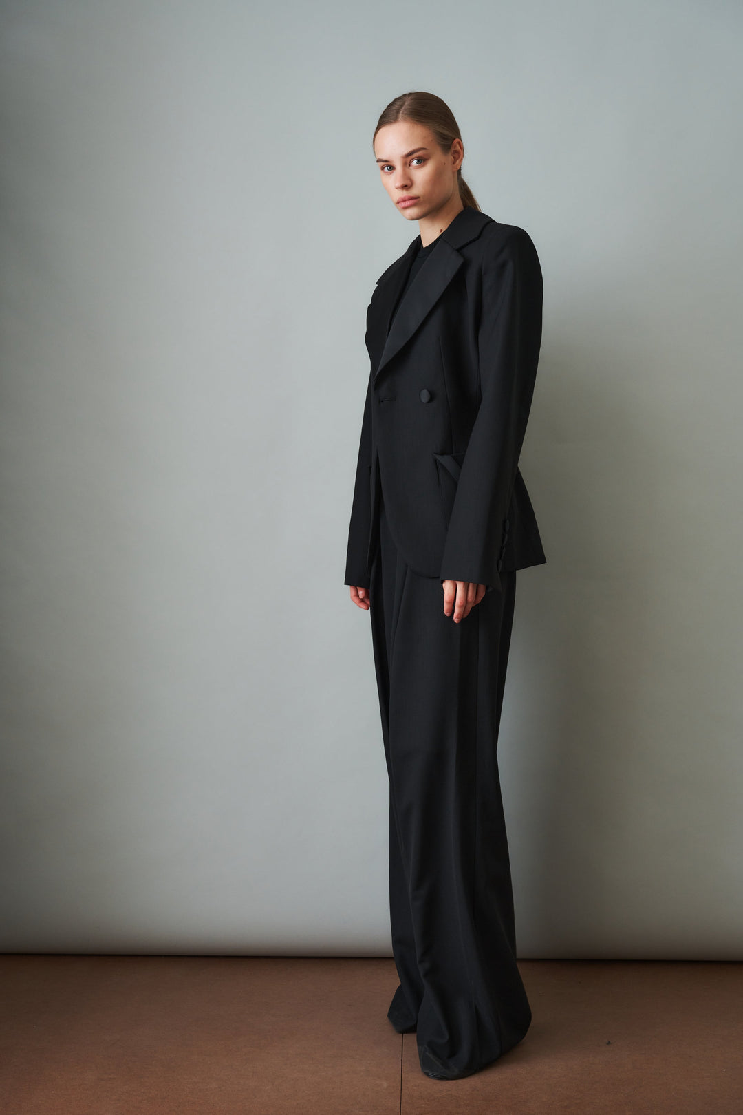 Women's black sculpted blazer with notched lapels and flap pockets