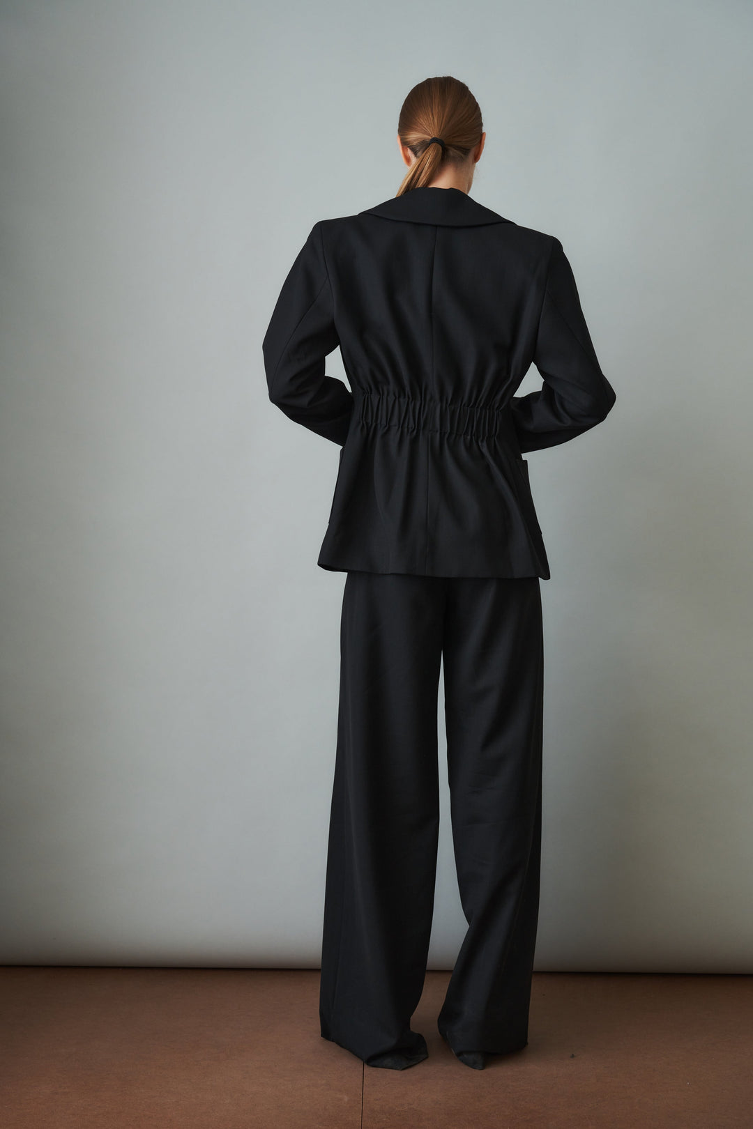 Women's black sculpted blazer with notched lapels and flap pockets