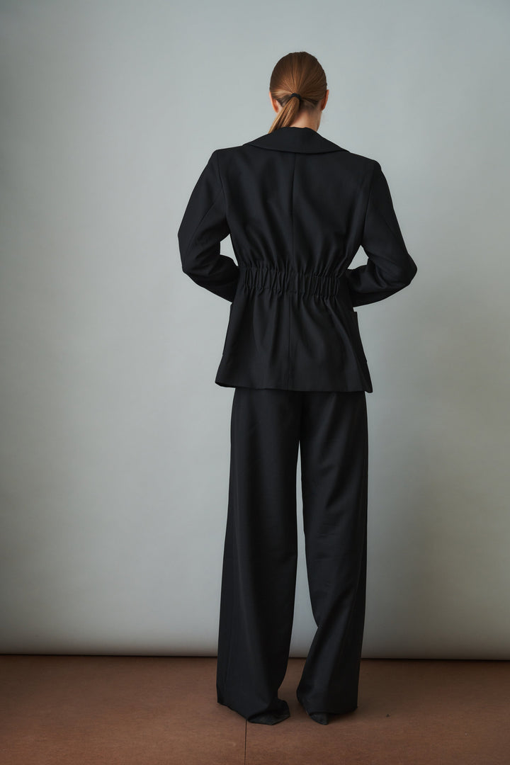 Women's black sculpted blazer with notched lapels and flap pockets