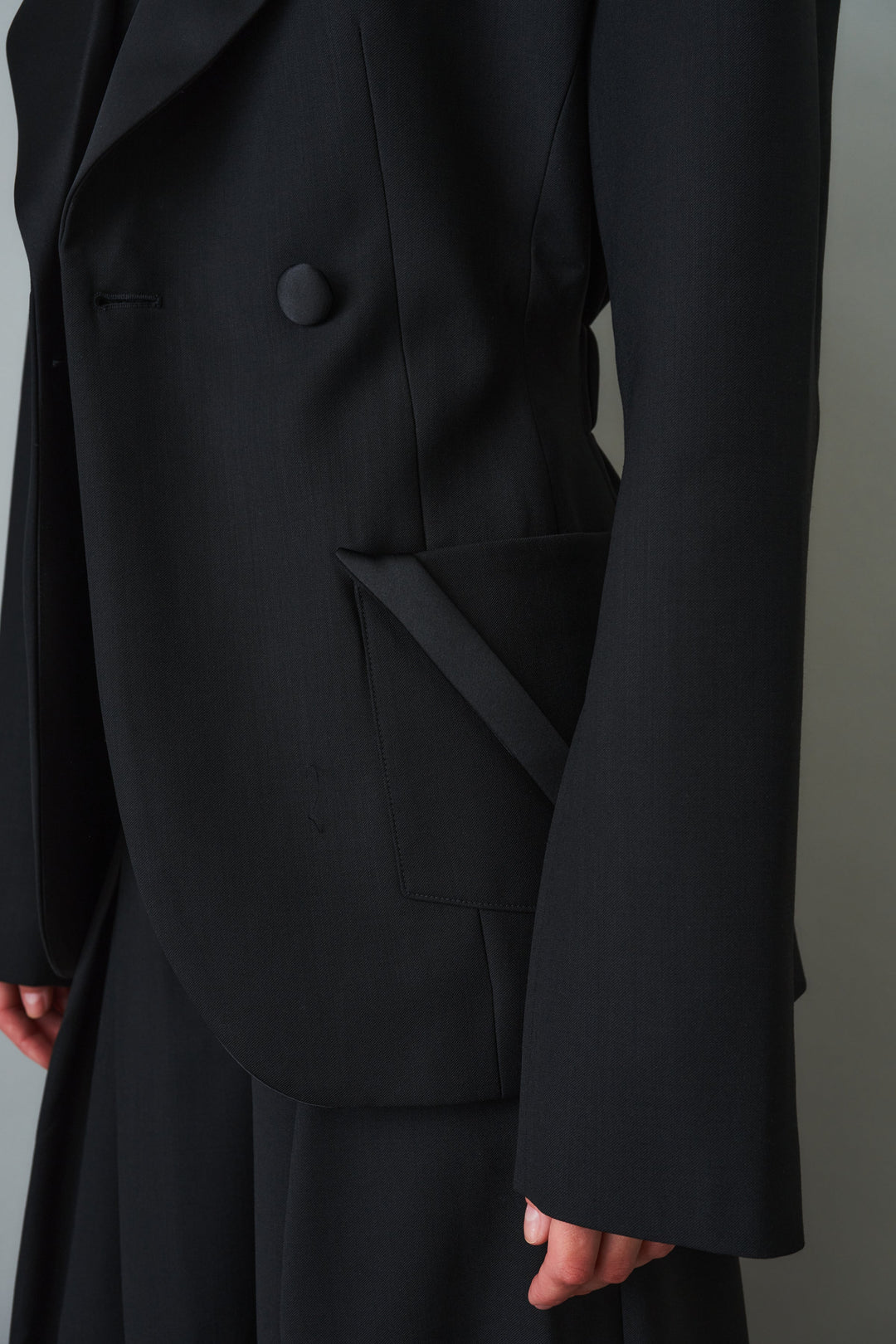 Women's black sculpted blazer with notched lapels and flap pockets