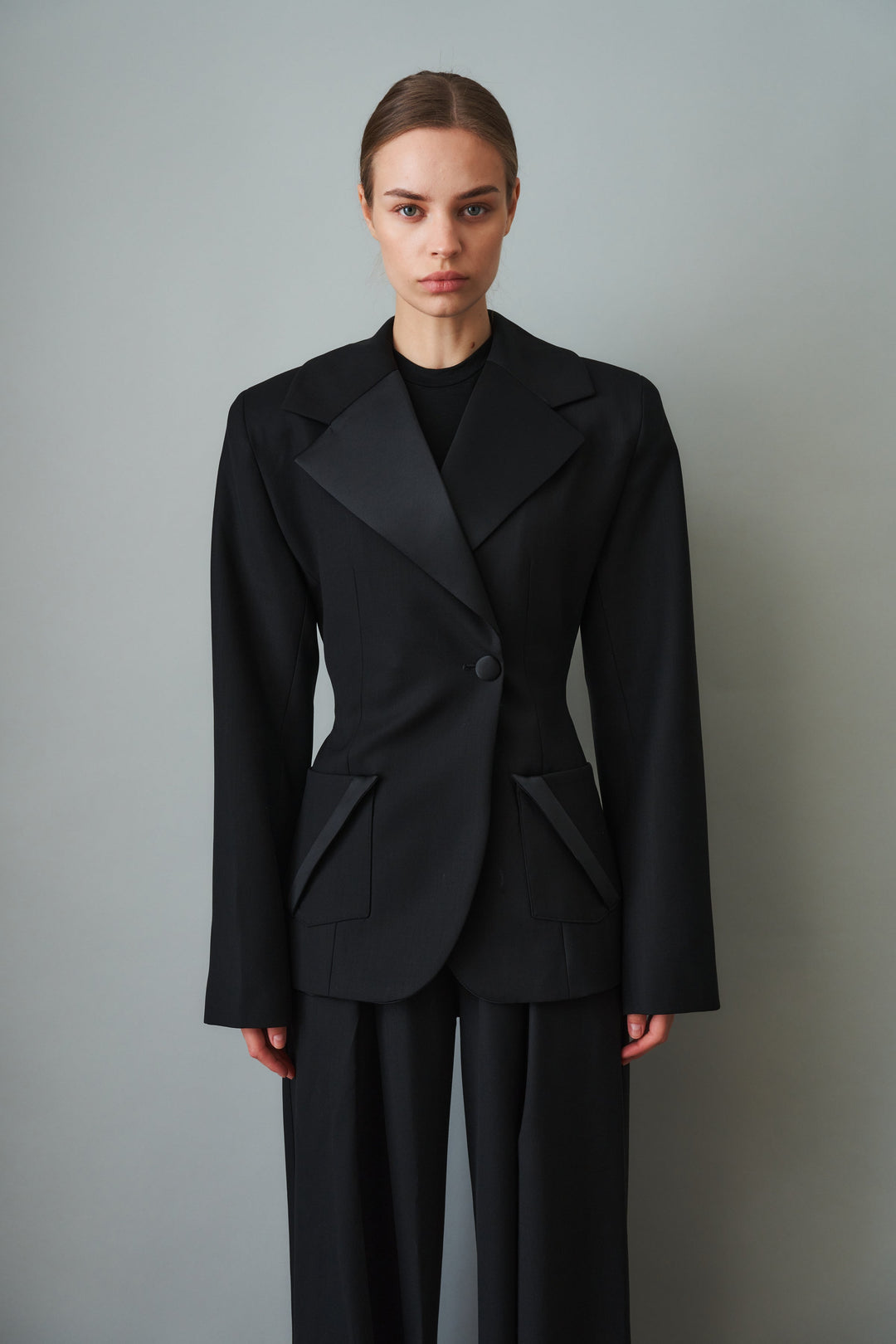 Women's black sculpted blazer with notched lapels and flap pockets