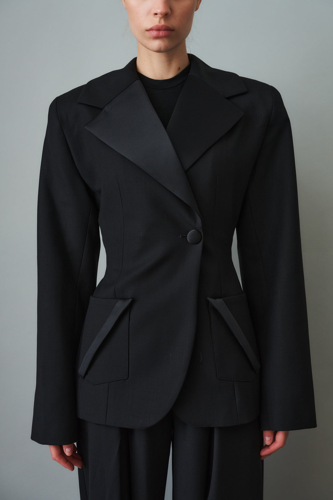 Women's black sculpted blazer with notched lapels and flap pockets