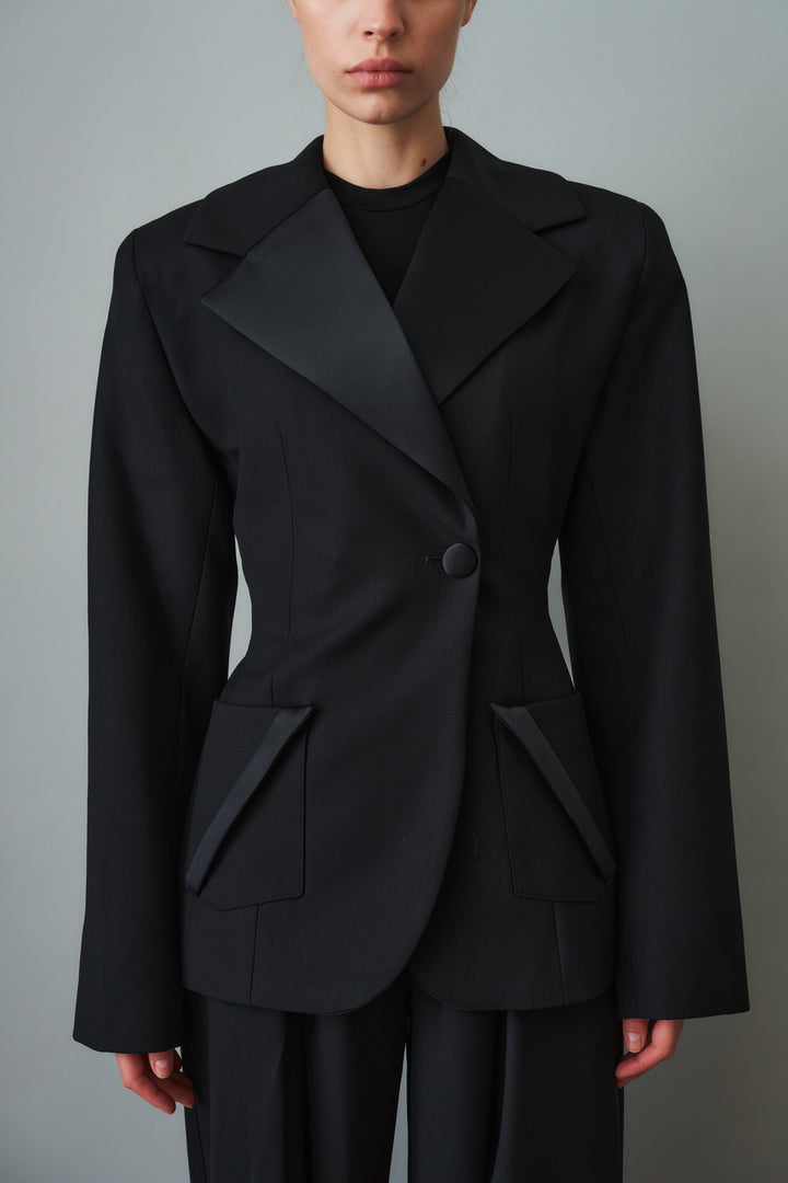 Women's black sculpted blazer with notched lapels and flap pockets