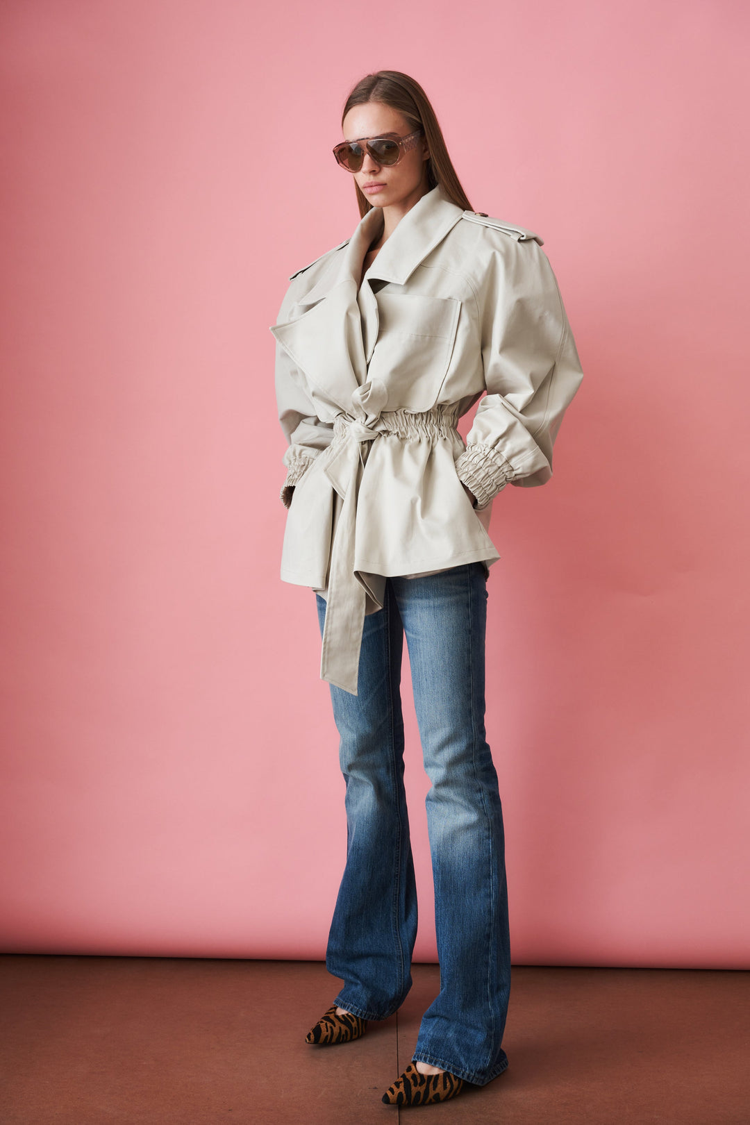 Women's beige trench coat with tie waist, wide collar and long sleeves