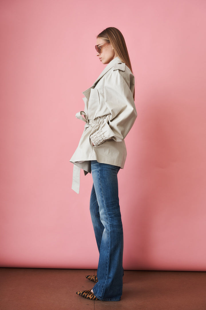 Women's beige trench coat with tie waist, wide collar and long sleeves