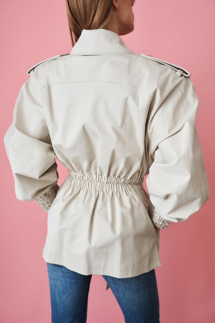 Women's beige trench coat with tie waist, wide collar and long sleeves