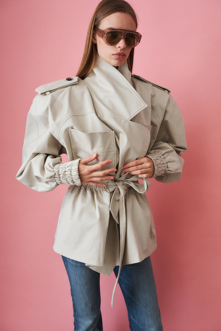 Women's beige trench coat with tie waist, wide collar and long sleeves