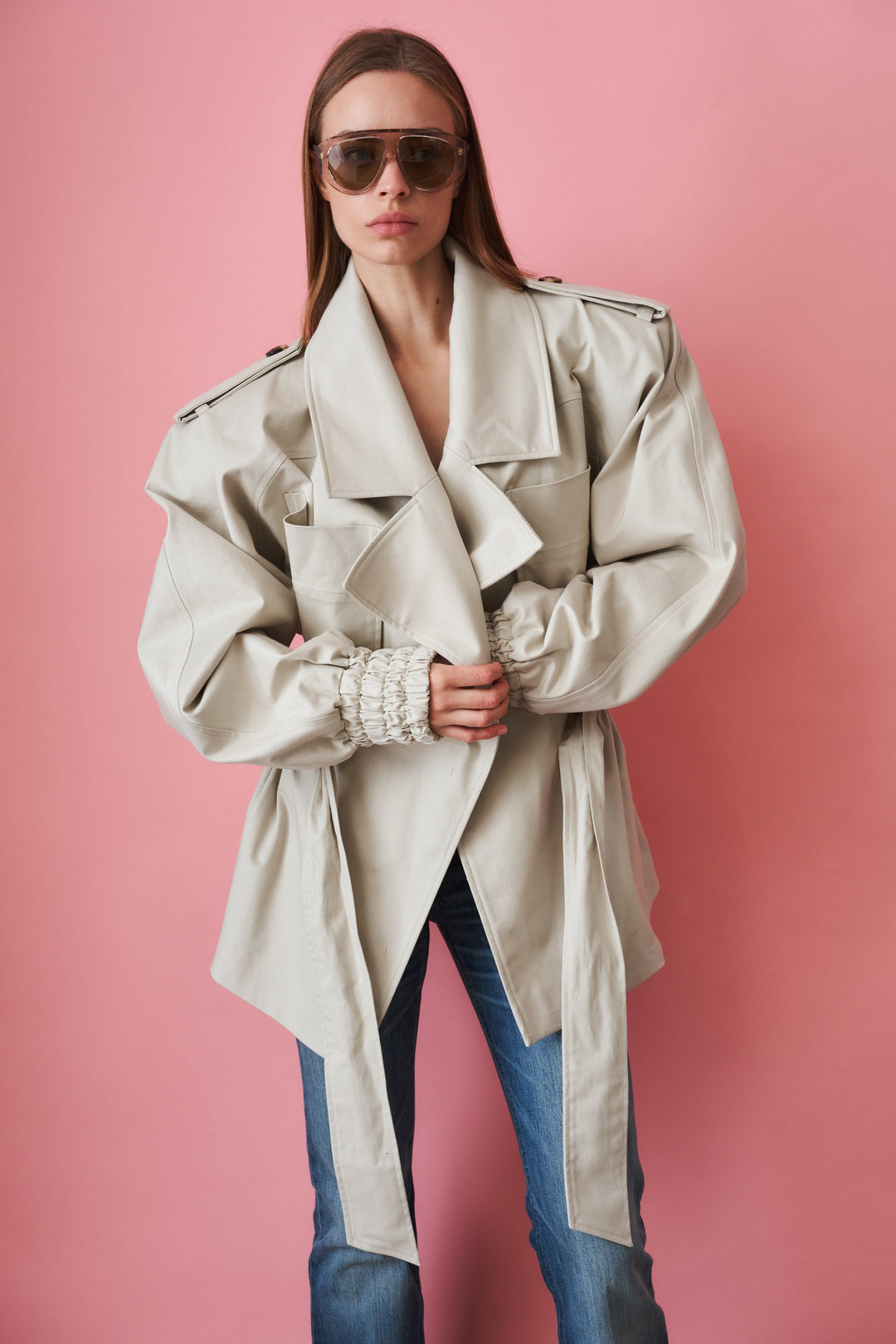 Women's beige trench coat with tie waist, wide collar and long sleeves