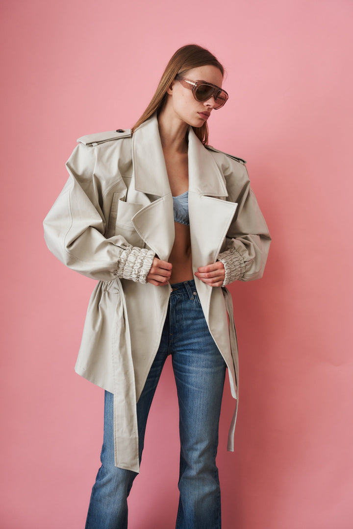 Women's beige trench coat with tie waist, wide collar and long sleeves
