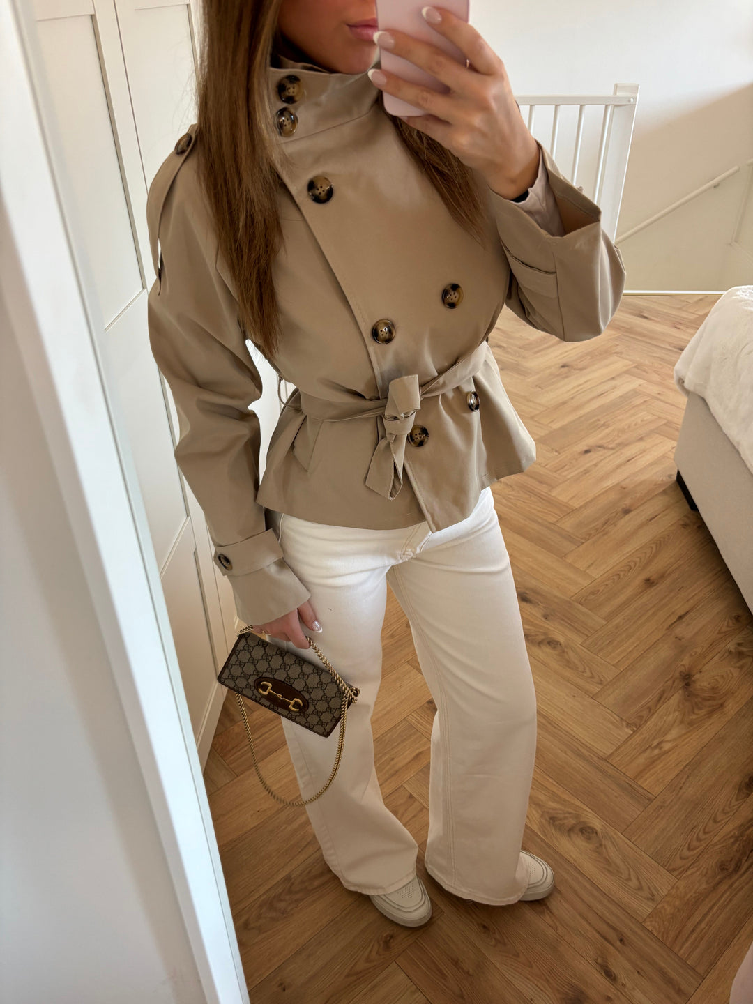 Women's beige belted trench jacket with high collar and button front
