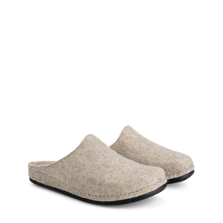 Beige closed-toe slip-on house slippers with black flat soles