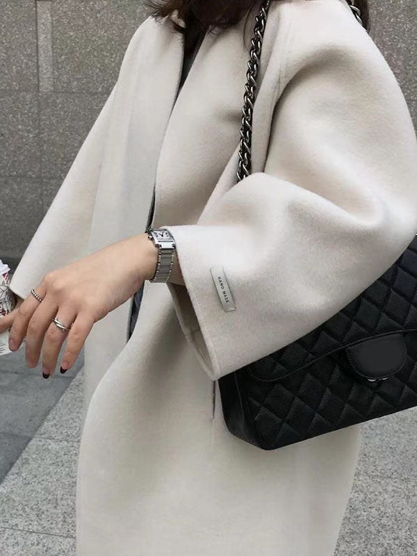 Women's collarless longline coat with open front and wide sleeves