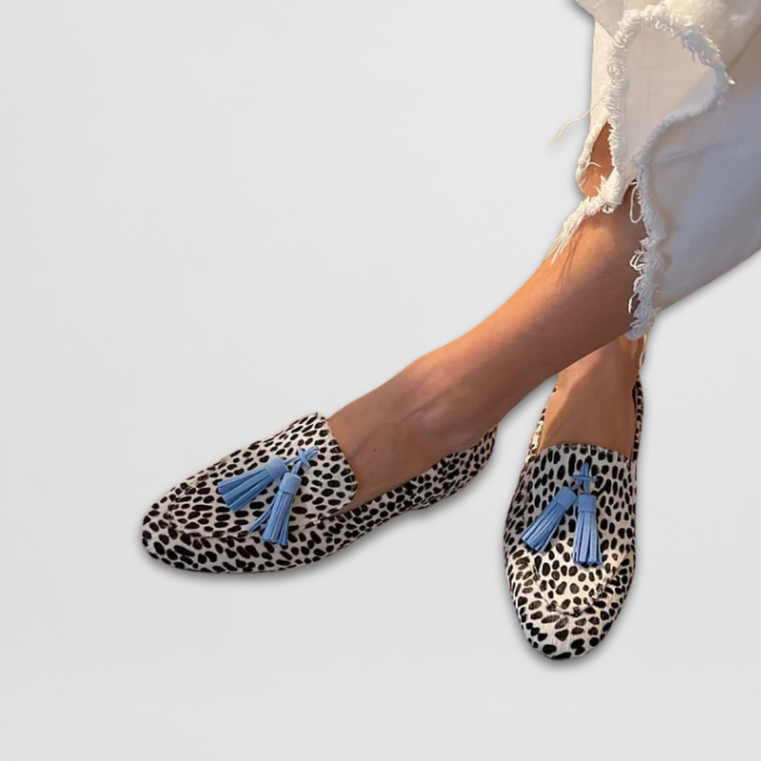 Women's white and black animal print flat loafers with blue tassel details