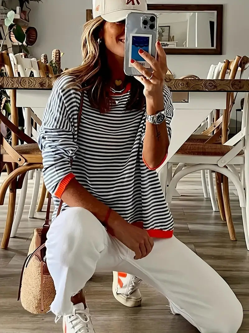 Women's black and white striped jumper with orange ribbed trims