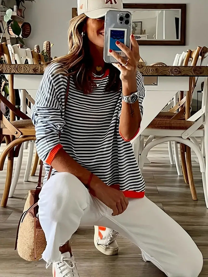 Women's black and white striped jumper with orange ribbed trims