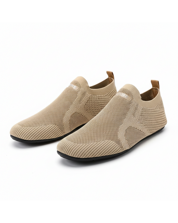 Knit slip-on shoes with round toes, pull tabs and flat black soles