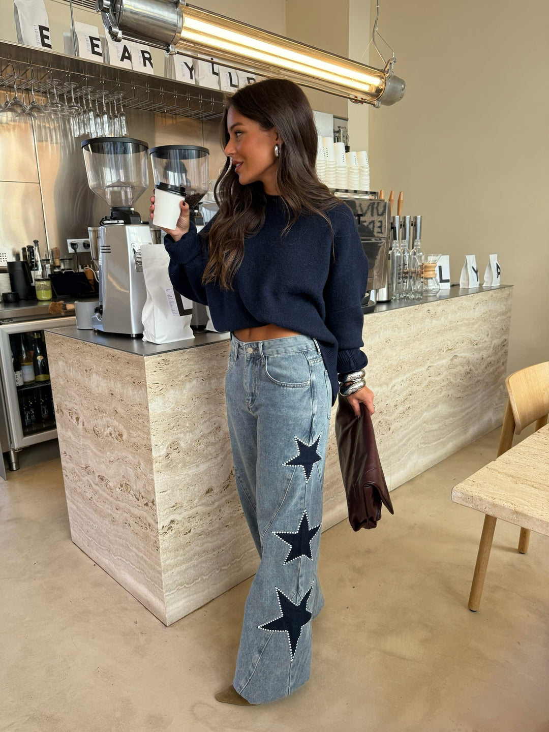 Women's light blue wide leg jeans with dark star details