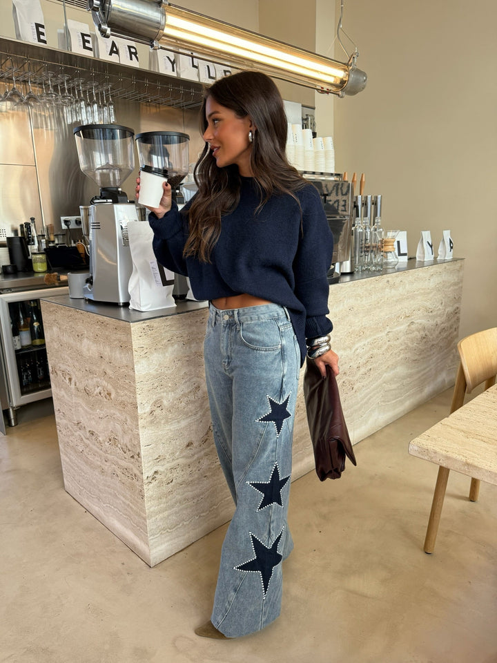 Women's light blue wide leg jeans with dark star details