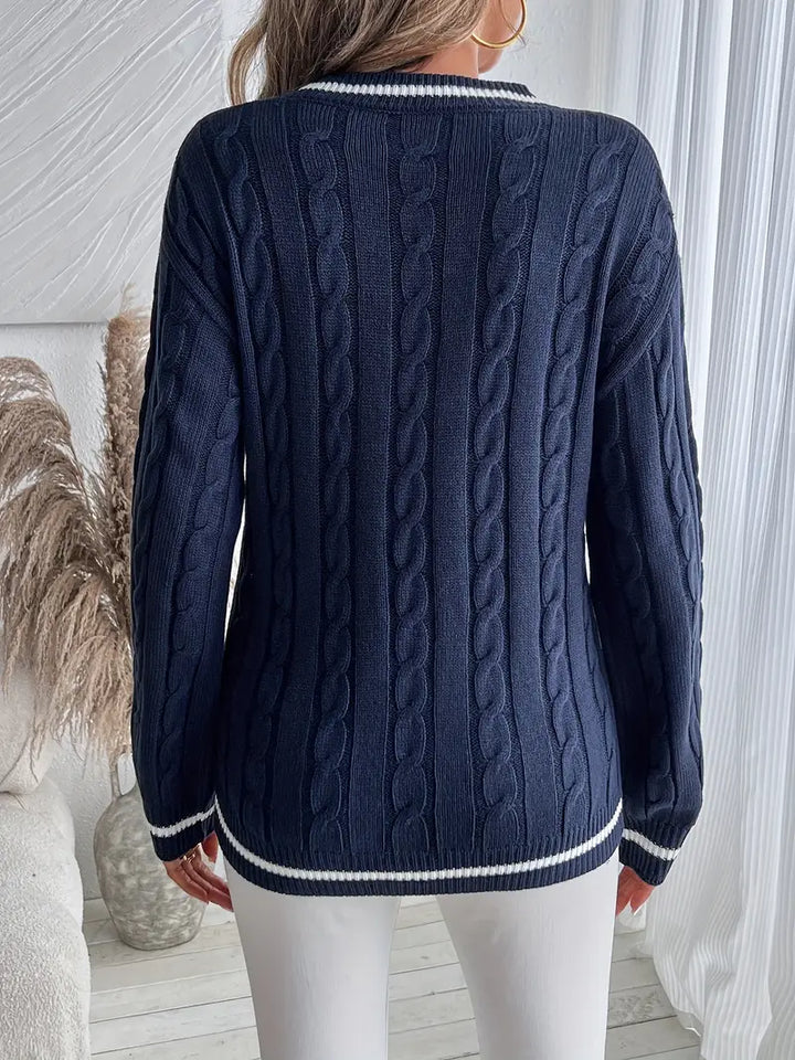 Women's navy cable knit V-neck sweater with white striped trim