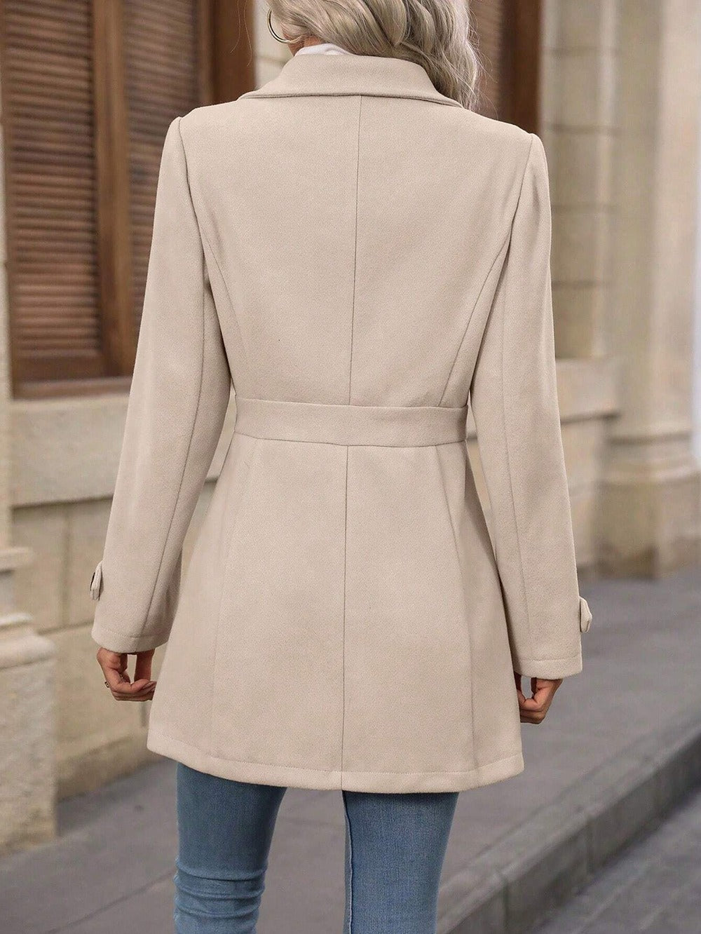 Women's belted trench coat with notched lapel, long sleeves and button front