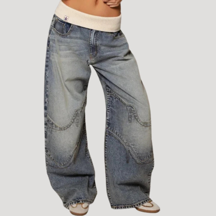 Women's light blue low-rise baggy jeans with wide legs and curved patchwork panels