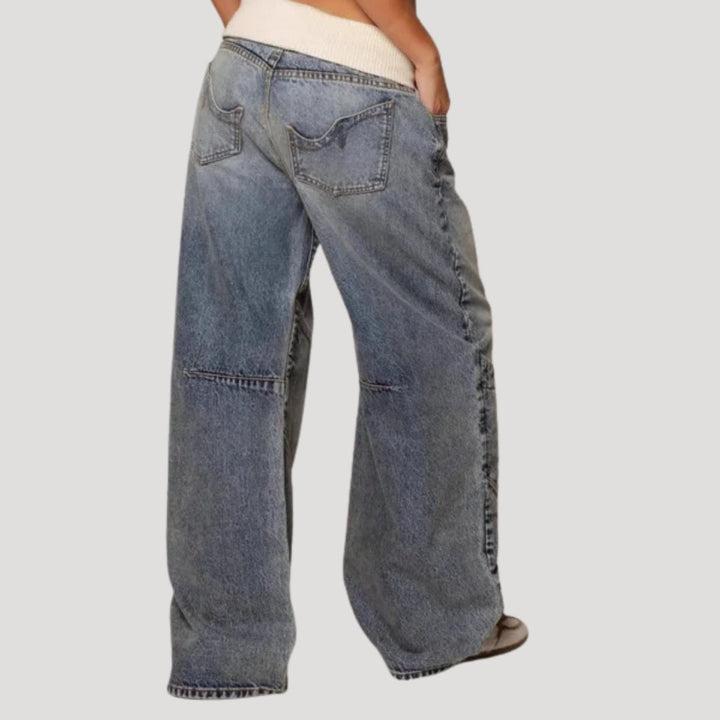 Women's light blue low-rise baggy jeans with wide legs and curved patchwork panels