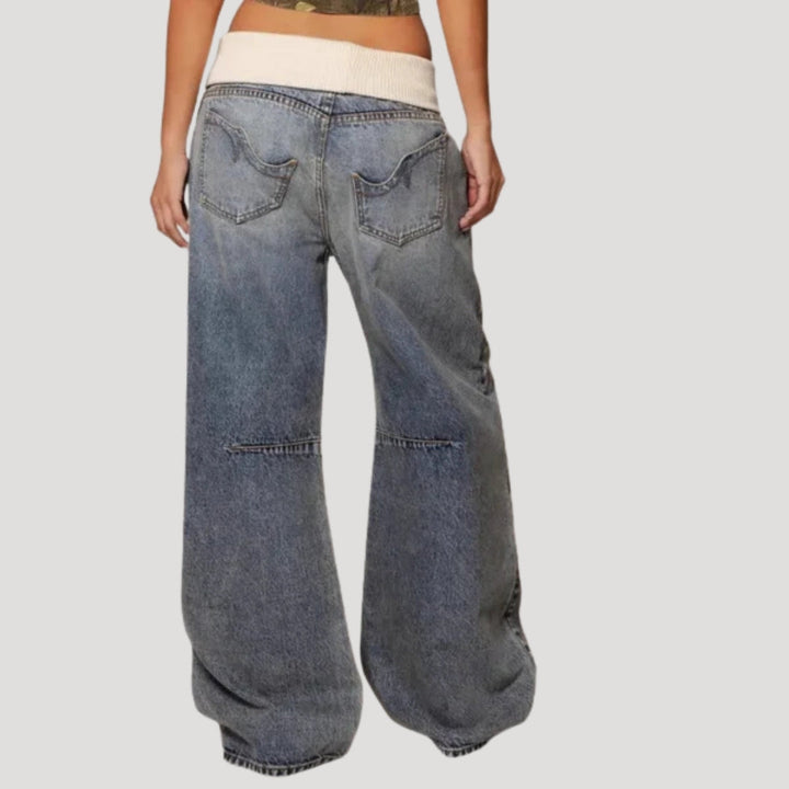 Women's light blue low-rise baggy jeans with wide legs and curved patchwork panels