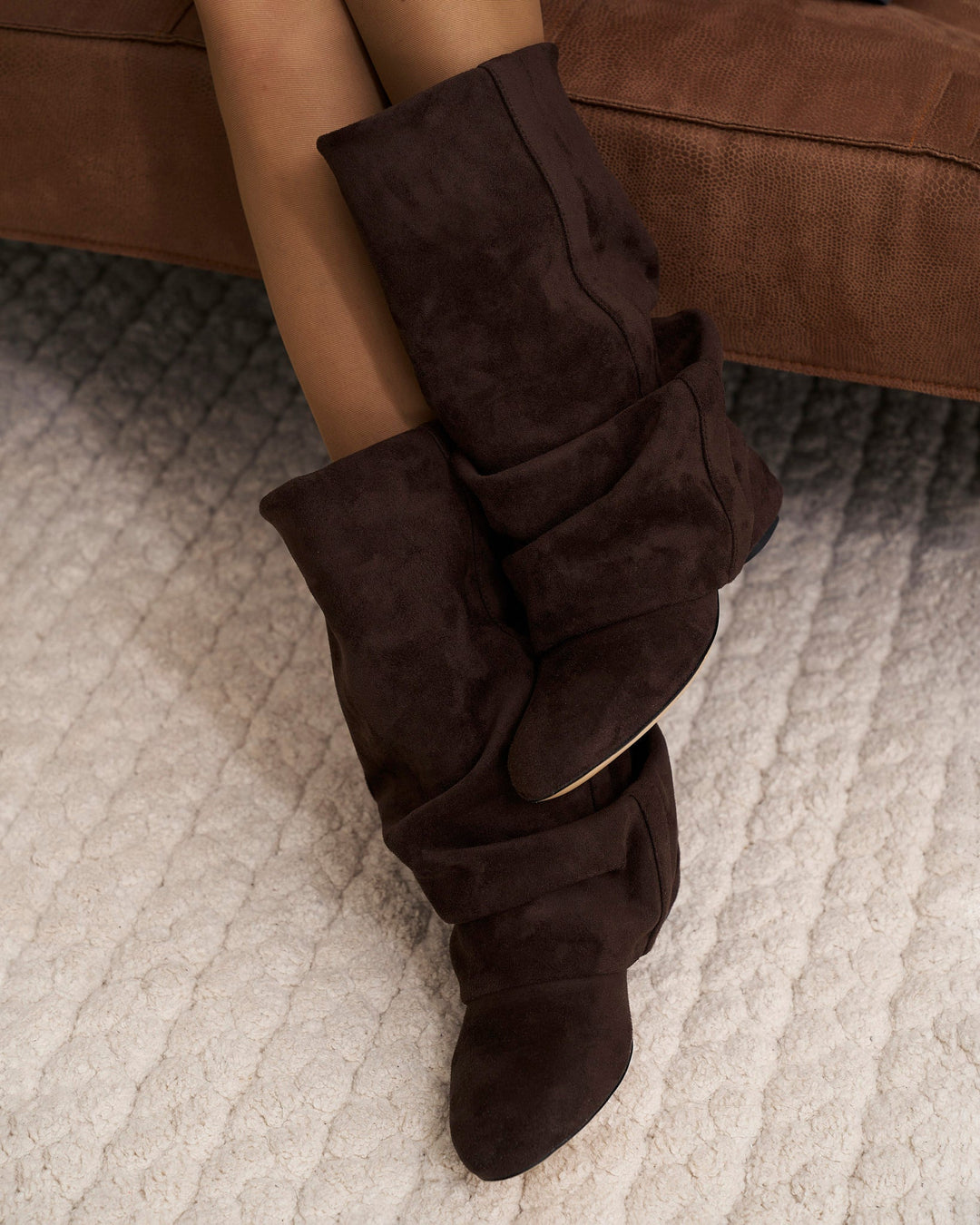 Women's dark brown slouchy knee-high boots with pointed toes and low heels