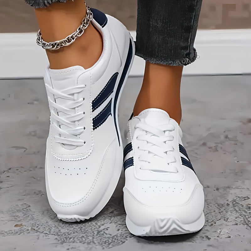 White women's lace-up sneakers with navy side stripes and round toes