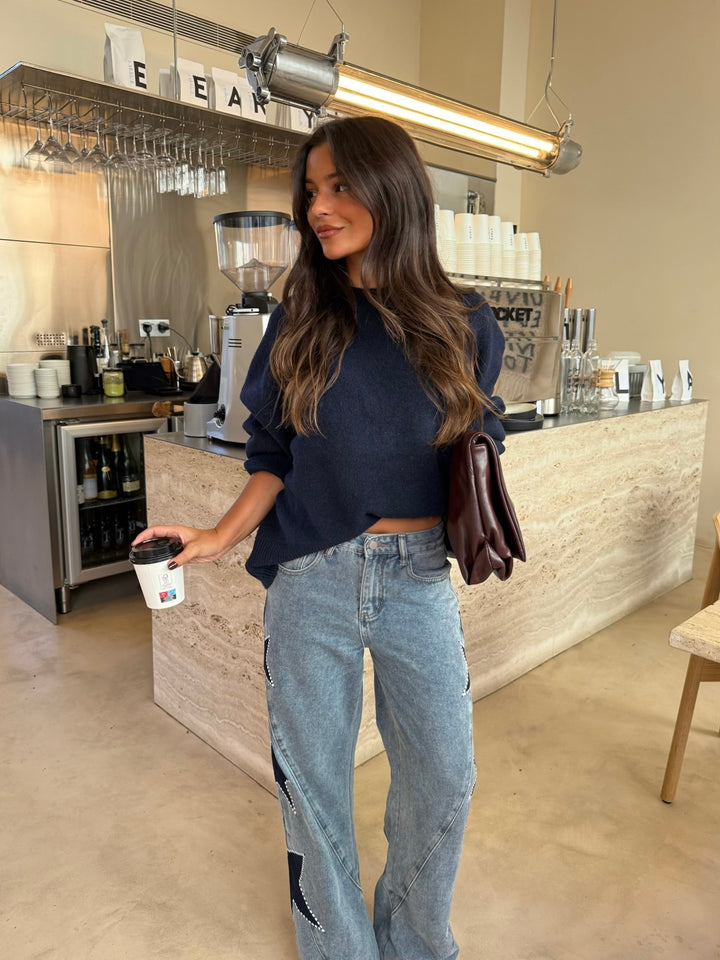 Women's light blue wide leg jeans with dark star details