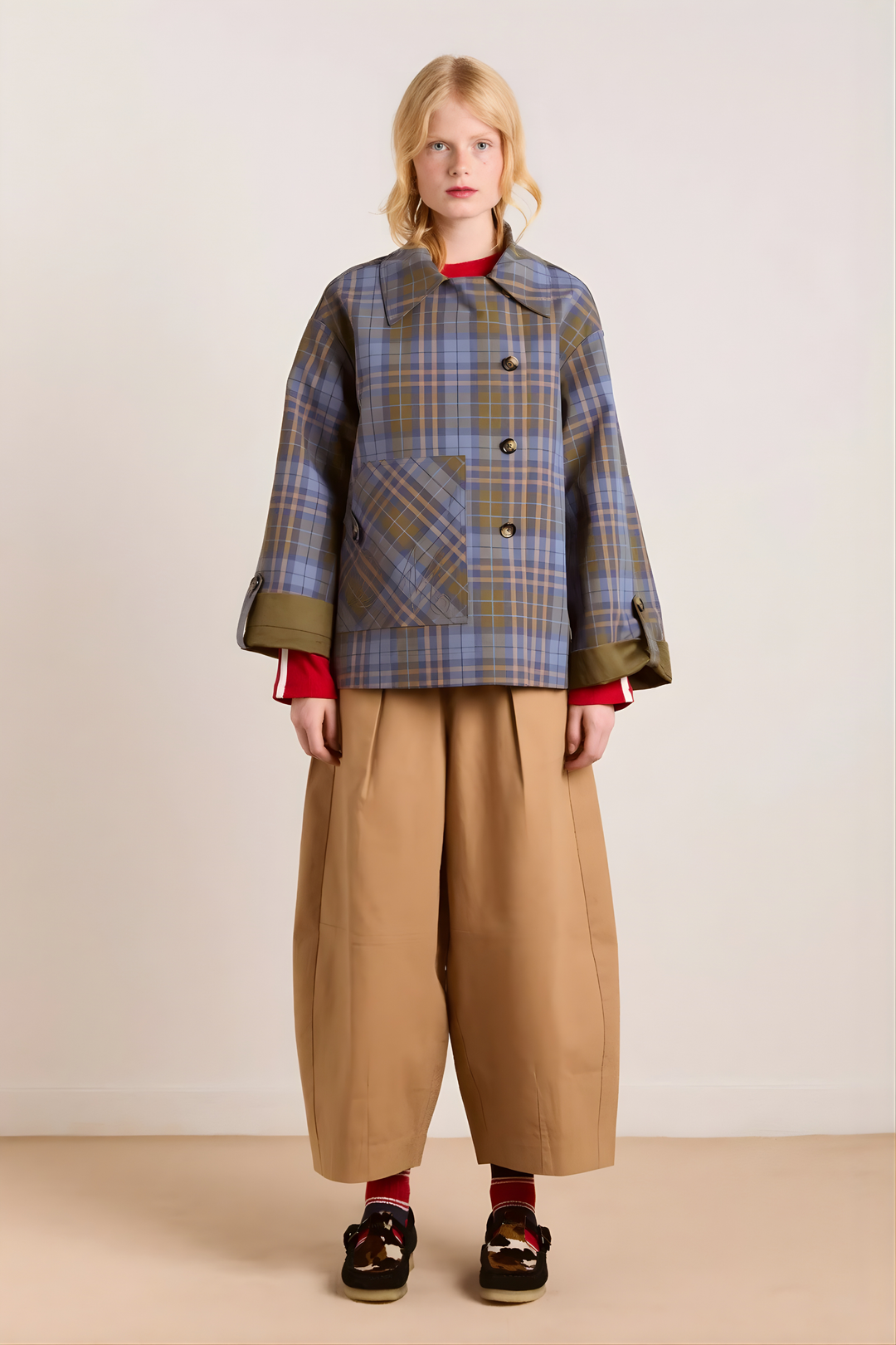 Women's brown jacket with blue plaid trim, raised collar and button front