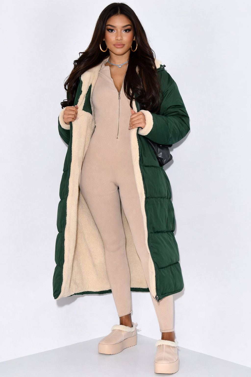 Women's long reversible hooded puffer coat shown with quilted and textured sides