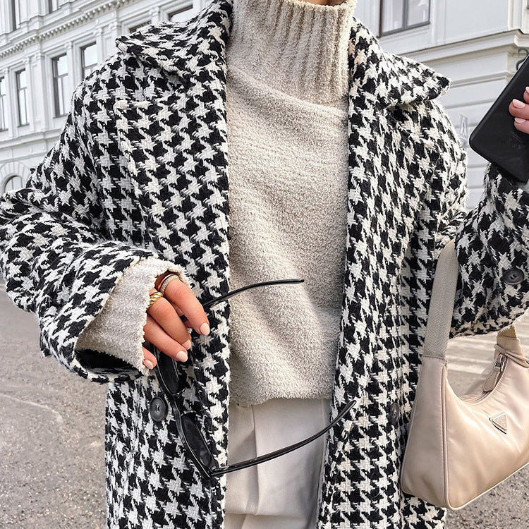Women's black and white houndstooth long coat with lapel collar and button front