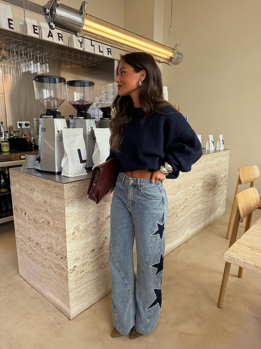 Women's light blue wide leg jeans with dark star details