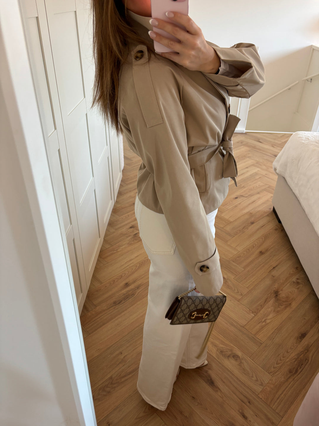 Women's beige belted trench jacket with high collar and button front