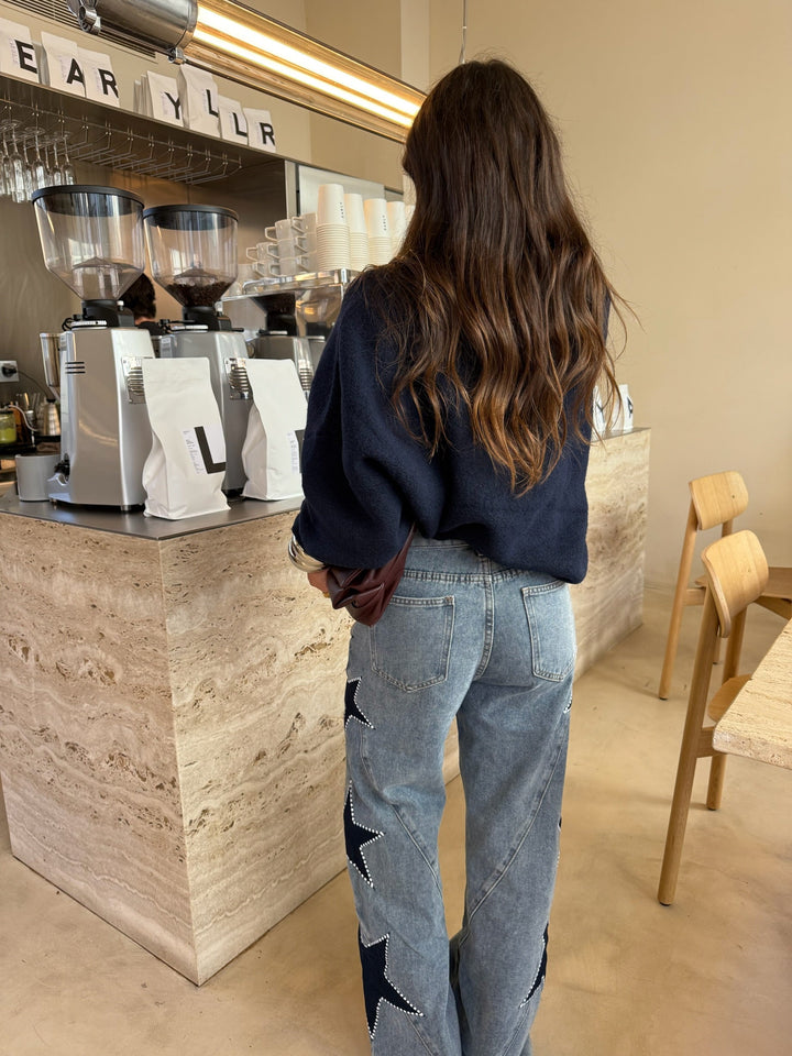 Women's light blue wide leg jeans with dark star details