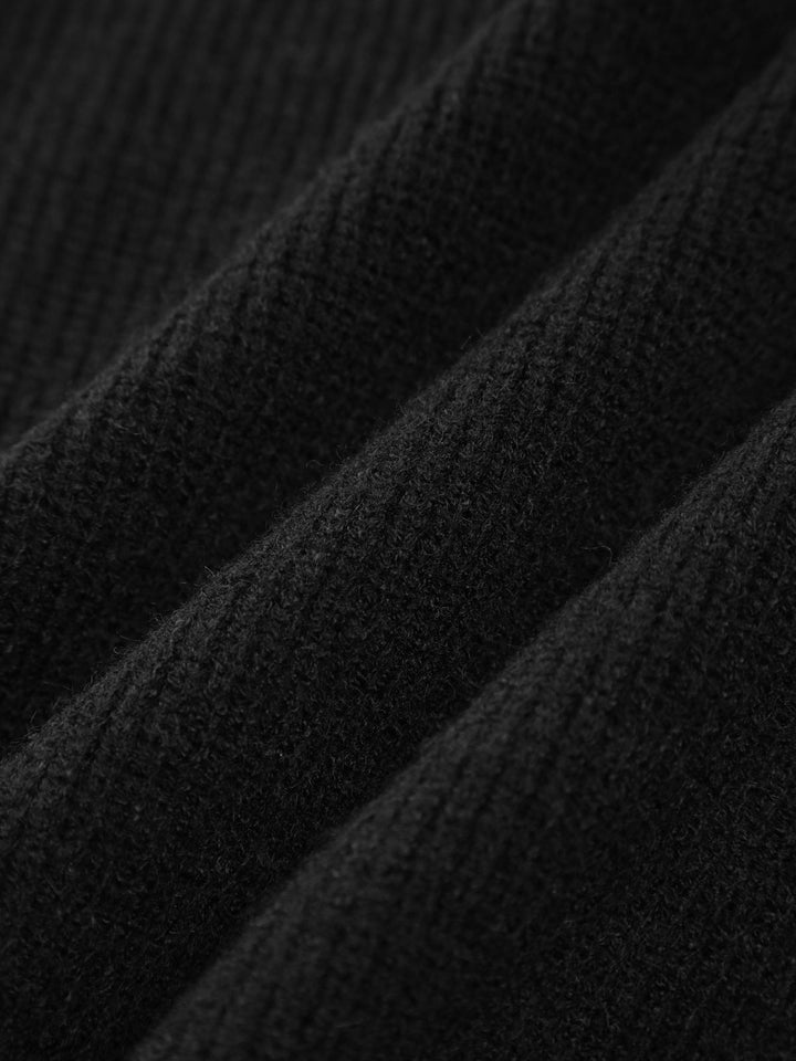 Women's black oversized knit sweater with contrast stitch seams and mock neck