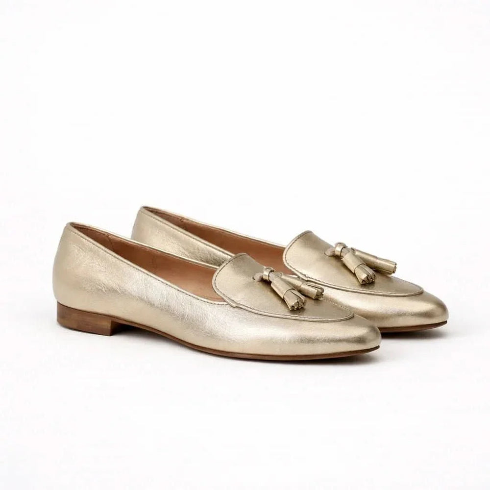 Women's metallic gold slip-on loafers with tassel detailing and low block heels