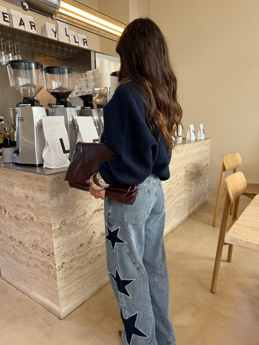 Women's light blue wide leg jeans with dark star details