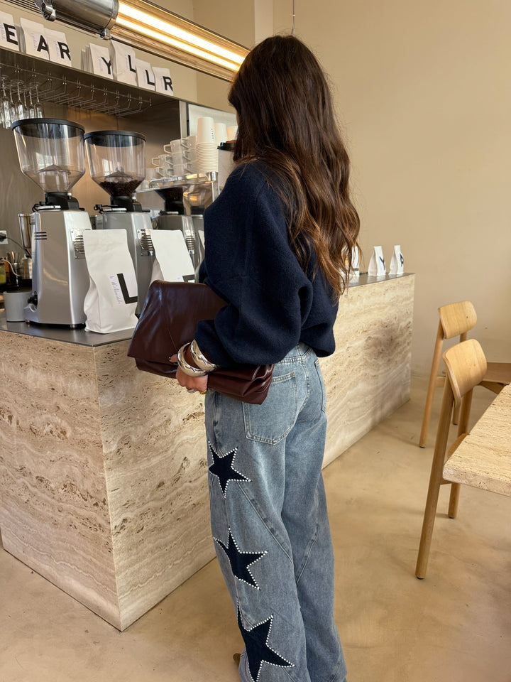 Women's light blue wide leg jeans with dark star details