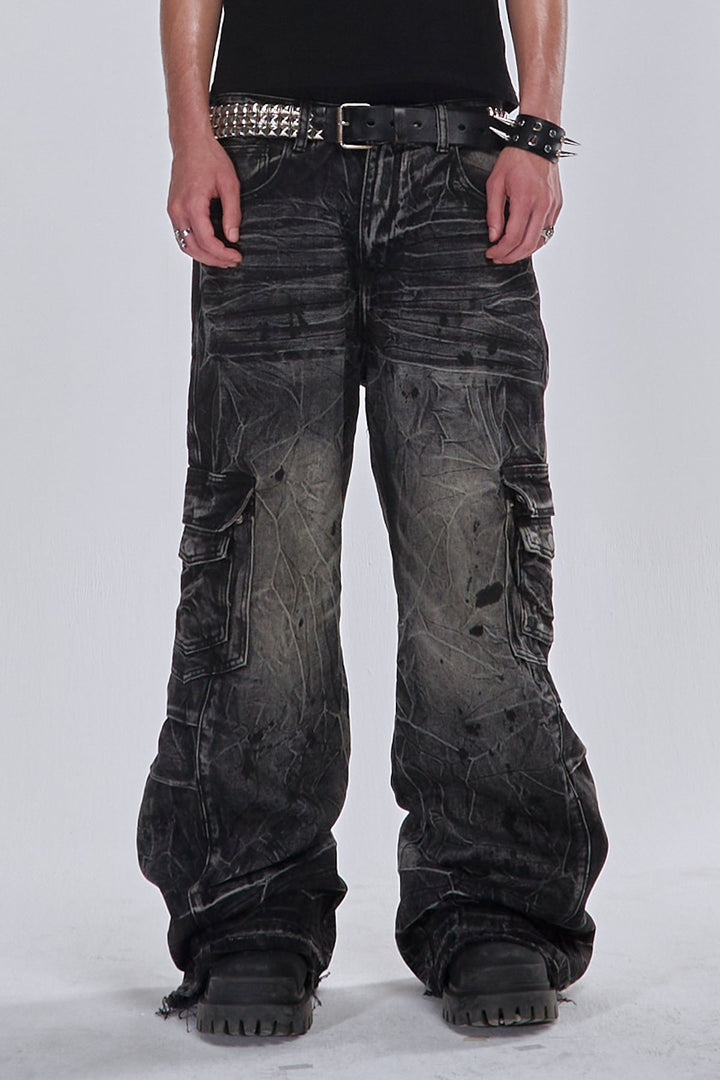 Black wide-leg cargo jeans with fractured textured finish and multiple utility pockets