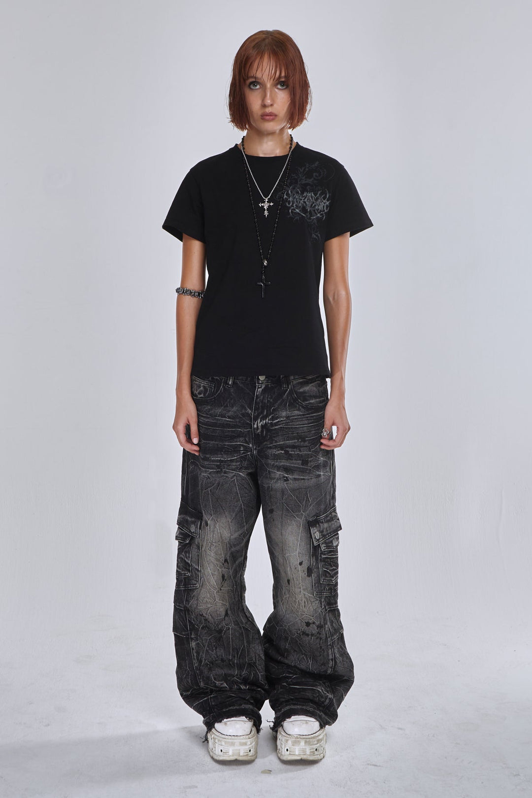 Black wide-leg cargo jeans with fractured textured finish and multiple utility pockets
