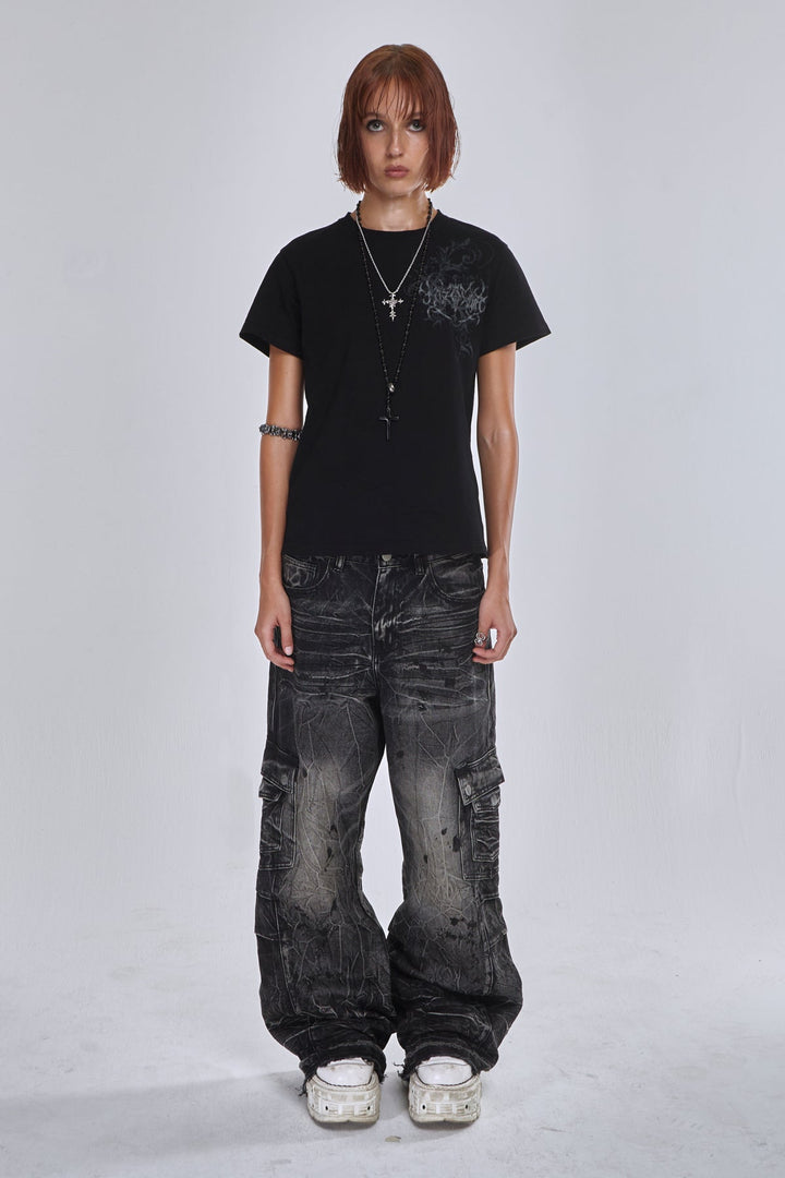 Black wide-leg cargo jeans with fractured textured finish and multiple utility pockets