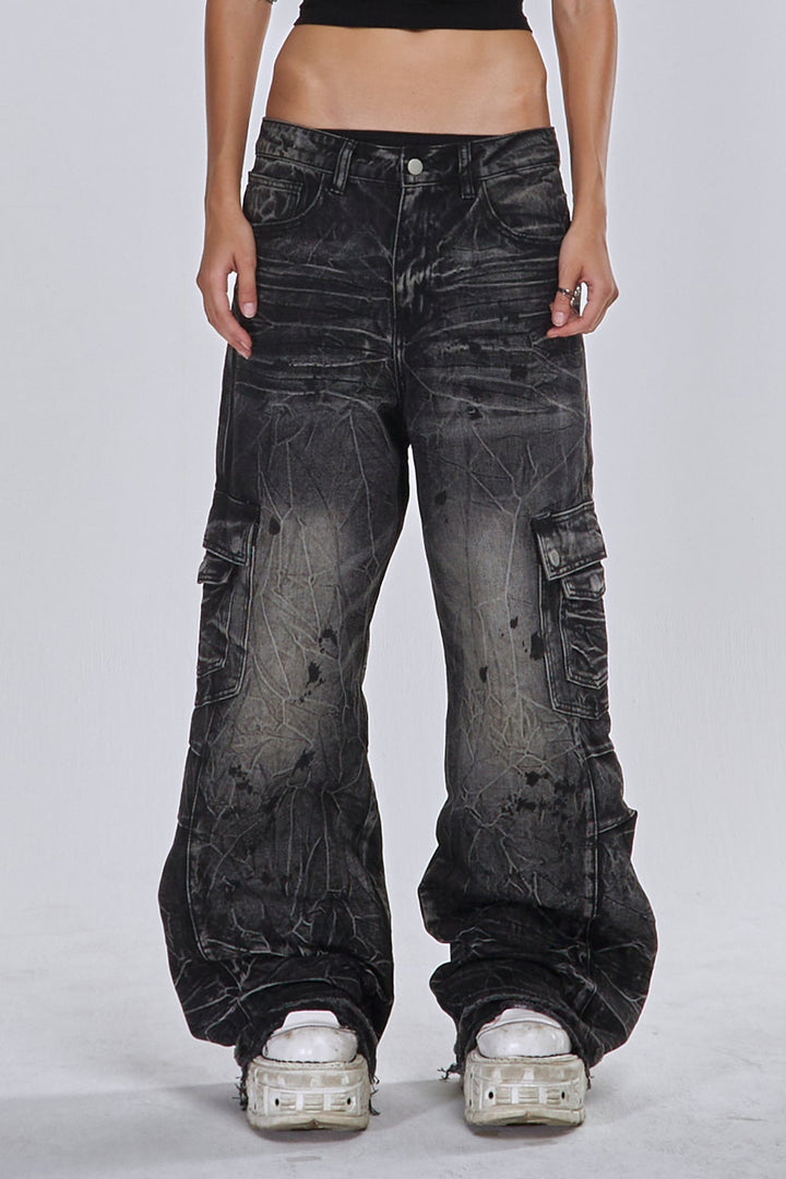 Black wide-leg cargo jeans with fractured textured finish and multiple utility pockets